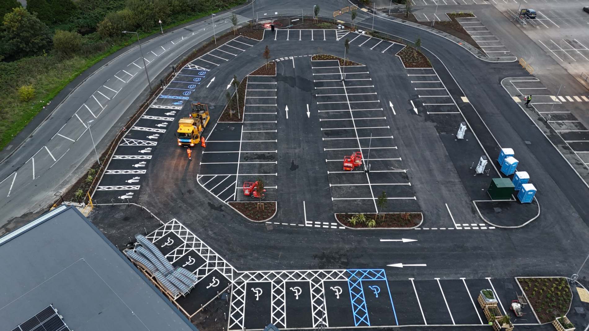 Aerial view of parking bays, accessible spaces, hatching and directional arrows at the new Aldi store in Wigan