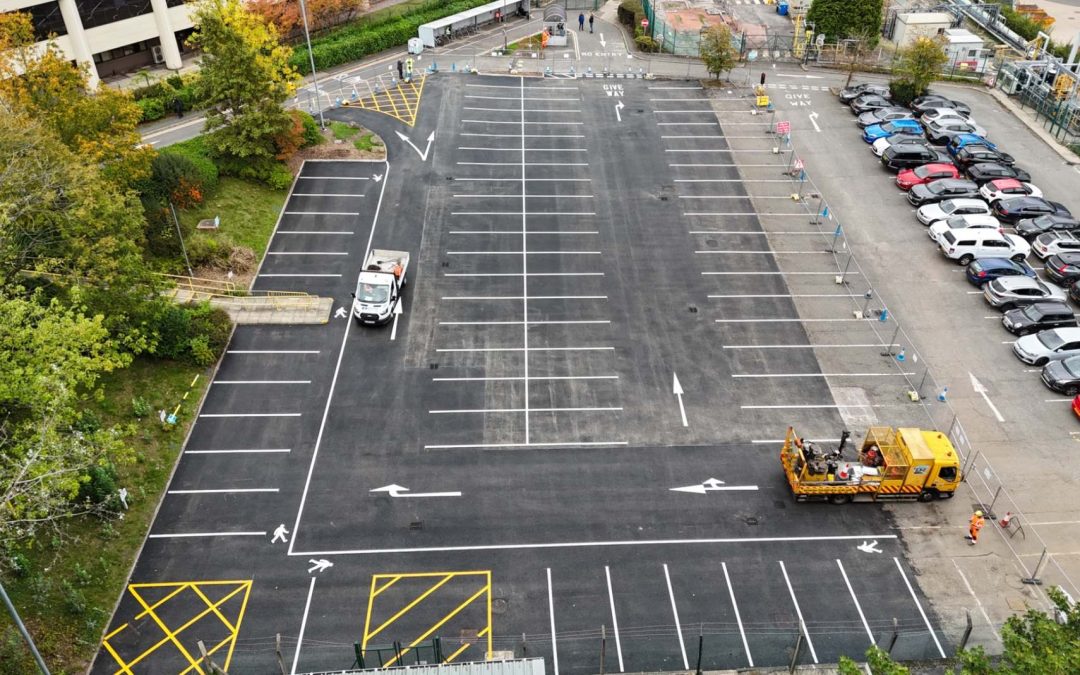 Aerial view of new car park line markings after resurfacing at AstraZeneca in Macclesfield, with Tomras road-marking truck on site