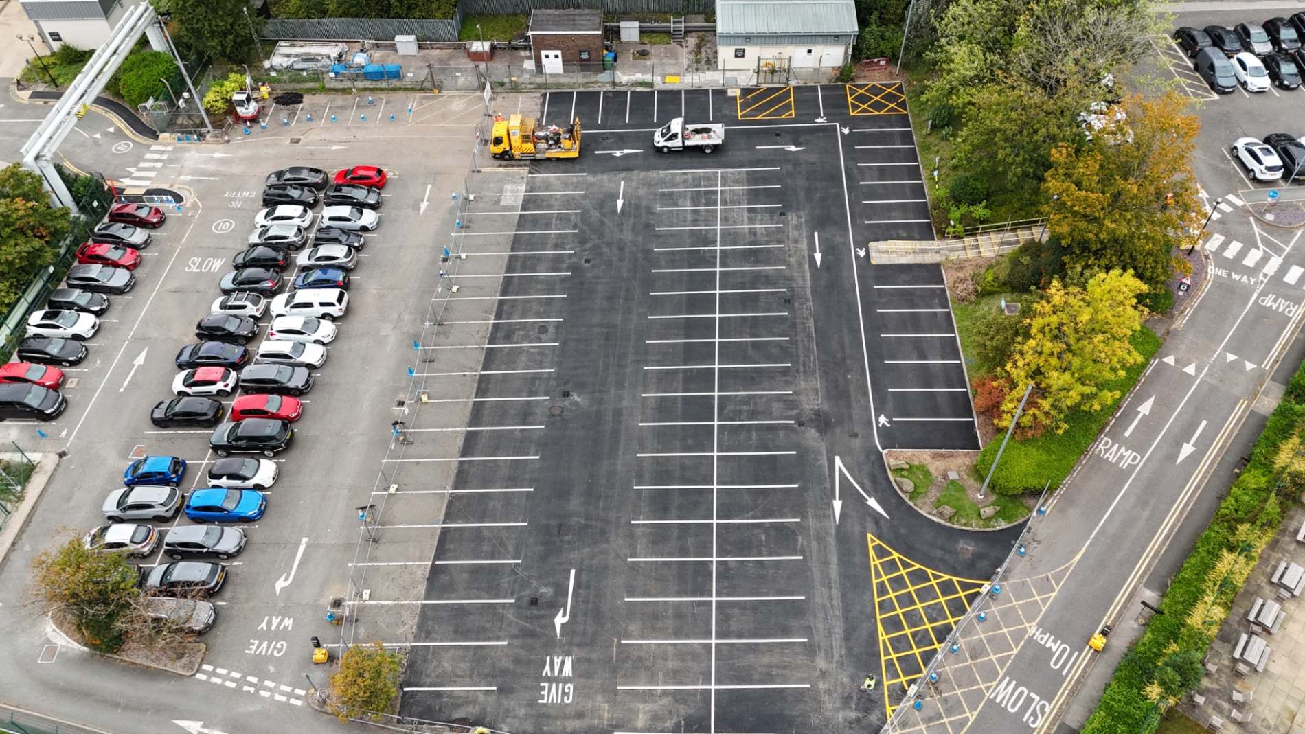 Relined car park at AstraZeneca in Macclesfield showing white parking bays, directional arrows and yellow hatching